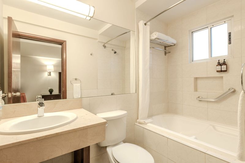 Queen room bathroom with bathtub